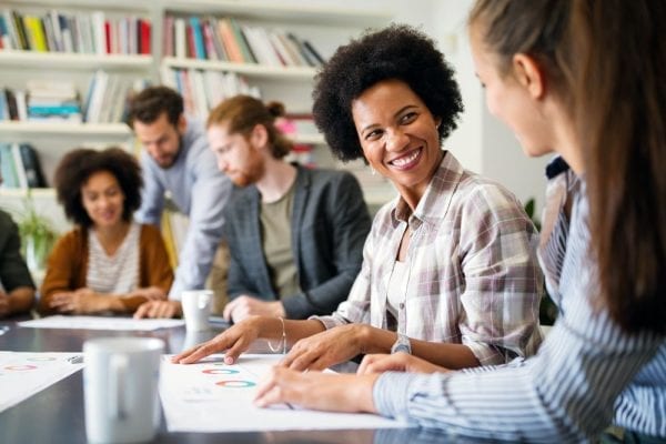 Group Of Business People Collaborating On Project In Office